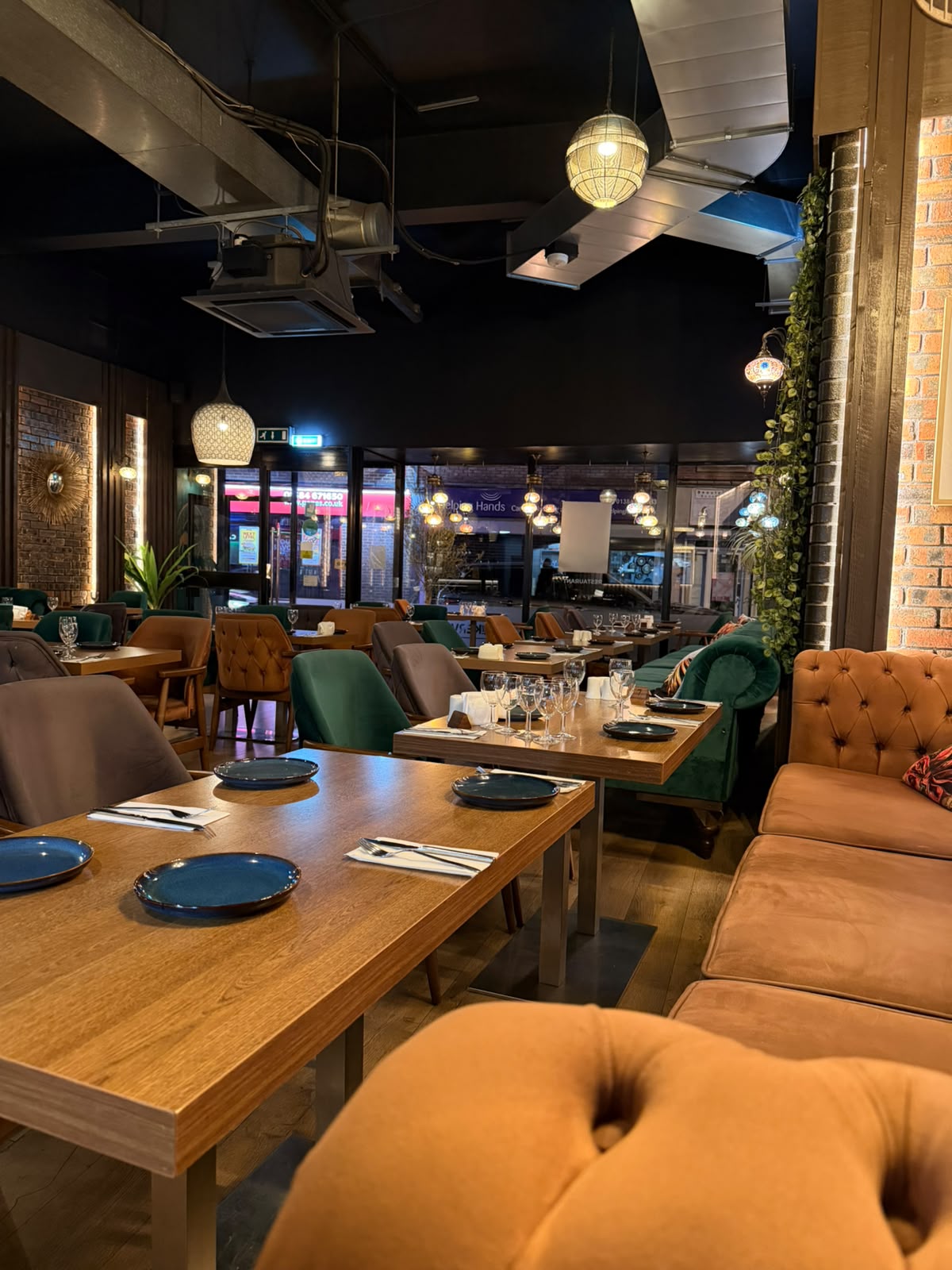 The Kervan dining room in the evening with velvet seating, Turkish lanterns and warm lighting